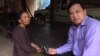 FILE - Im Chaem, the former Khmer Rouge secretary of Preah Net Preah district, Banteay Mean Chey province, with VOA Khmer's reporter Sok Khemara in her home, August 11, 2015. (VOA Khmer) 
