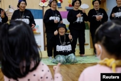 Park Jeom-sun, 81, the leader of the granny rap group "Suni and Seven Princesses", and the members rap in front of young children at a daycare center in Chilgok, South Korea, February 6, 2024. (REUTERS/Kim Soo-hyeon)
