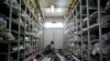 FILE - A forensic anthropologist of the International Commission on Missing Persons (ICMP) works to identify the remains of a victim of the Srebrenica massacre, at the ICMP center near Tuzla, Bosnia and Herzegovina, July 6, 2016.
