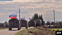 An image grab taken from AFP TV, Jan. 17, 2019, shows Russian army vehicles on patrol in the area of Arimah, just west of Manbij, the northern city near the Turkish border where a day earlier a suicide attack on a restaurant killed four Americans. 