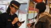 An airport security officer (L) checks a passenger's passport and boarding pass at Taipei Songshan Airport on March 10, 2014. 