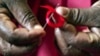 A Kenyan woman prepares ribbons ahead of World Aids Day at Beacon of Hope center, a non-government organization formed to address women's problem of HIV/AIDS in Nairobi (File)