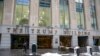 FILE - People walk by The Trump Building office building at 40 Wall Street in New York, Jan. 7, 2022. 