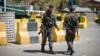 Policemen stand guard at the entrance of the now-closed U.S. Embassy in Sanaa, Yemen, Feb. 11, 2015.