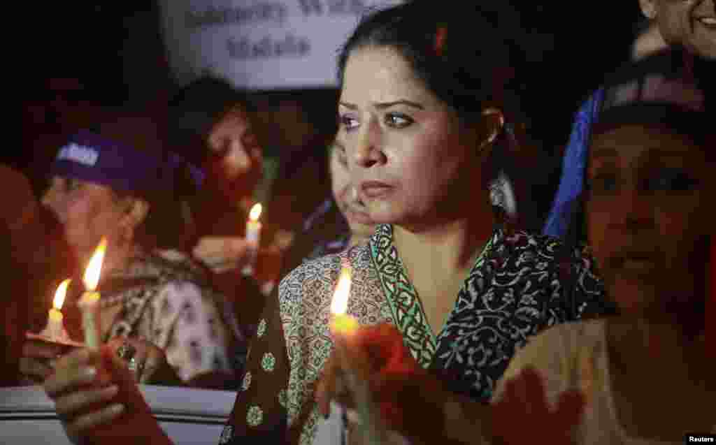 Women hold candles during a rally condemning the attack on Malala Yousafzai, Karachi, Pakistan, October 11, 2012. 