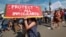 FILE - Supporters of the Deferred Action for Childhood Arrivals, or DACA chant slogans and carry signs while joining rally in downtown Los Angeles, Sept. 4, 2017.