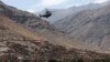 A view shows a helicopter flying over the devastated village of Adassil