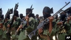 FILE - Islamist fighters loyal to Somalia's al-Qaida inspired al-Shabab group perform military drills at a village in Lower Shabelle region, some 25 kilometers outside Mogadishu, Feb. 2011. 