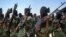FILE - Islamist fighters loyal to Somalia's al-Shabab group perform military drills at a village in Lower Shabelle region, some 25 kilometers outside Mogadishu.