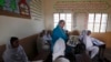 A teacher displays a flash card with an illustration depicting a student molested by a teacher, while describing measures to take when sexual harassment occurs, during a class in Shadabad Girls Elementary School in Gohram Panhwar village in Johi, some 325