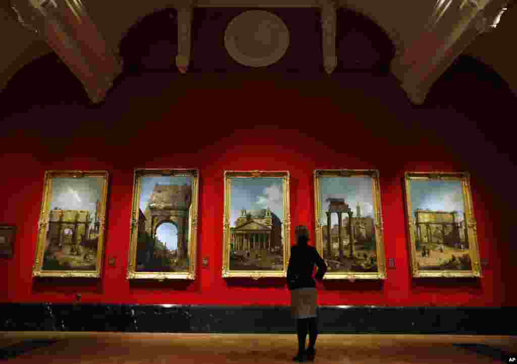 A woman looks at Canaletto&#39;s paintings of Roman views at the Queen&#39;s Gallery at Buckingham Palace in London.