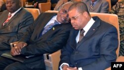Central Africa's newly appointed Prime Minister Nicolas Tiangaye (R) speaks with KNK party general secretary Louis Oguere Ngaikoumon (L) on January 17, 2013 in Bangui during a ceremony. 