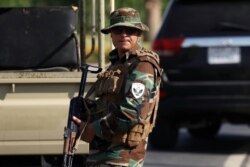 A member of the Iraqi Kurdish security stands guard outside the restaurant where a gunman opened fire in Irbil, the capital of northern Iraq's Kurdish autonomous region, July 17, 2019.