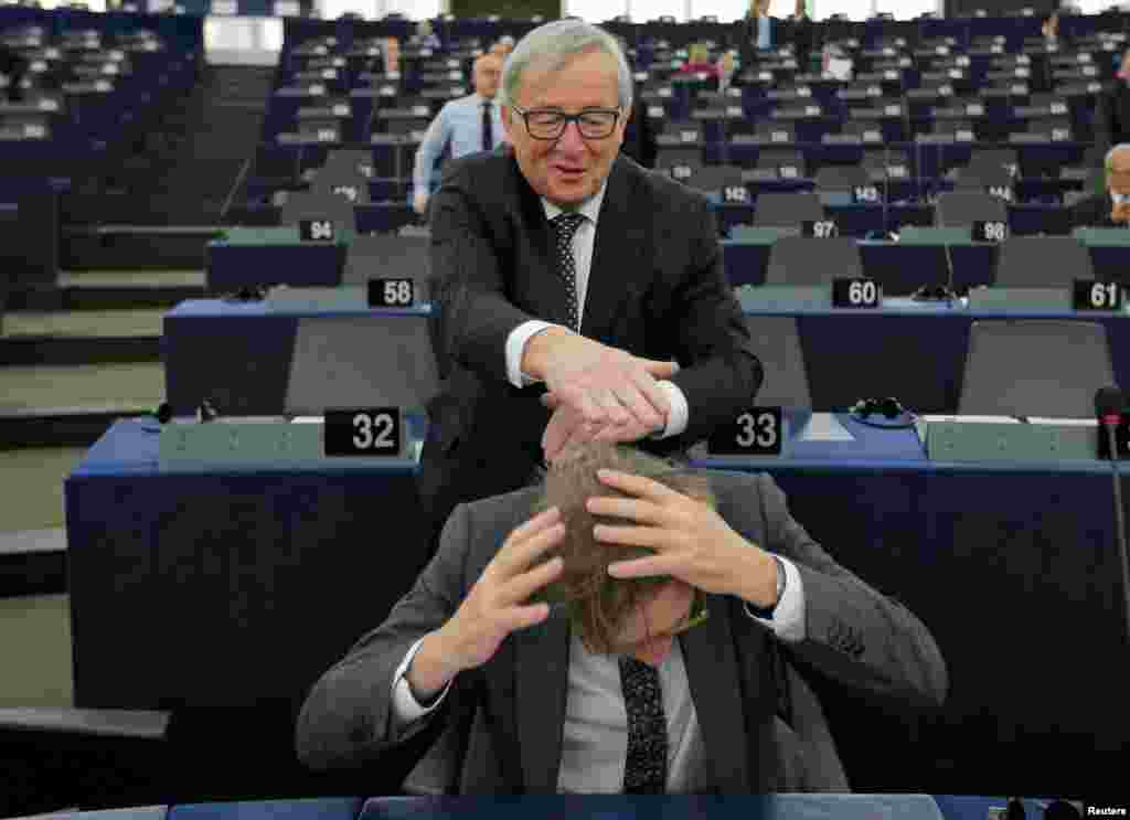 European Commission President Jean-Claude Juncker jokes with European Union&#39;s chief Brexit negotiator Guy Verhofstadt ahead of a debate on the Future of Europe at the European Parliament in Strasbourg, France.