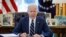 FILE - President Joe Biden signs the American Rescue Plan, a package of economic relief measures to respond to the impact of the coronavirus disease (COVID-19) pandemic, inside the Oval Office at the White House in Washington, March 11, 2021.