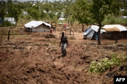 FILE - A young South Sudanese refugee walks in the Pagirinya refugee settlement in Adjumani, north of Kampala, Uganda, Aug. 29, 2016.
