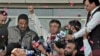 Former Pakistani President Pervez Musharraf, center, gestures to supporters upon arriving at the airport, Karachi, March 24, 2013.
