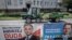FILE - Election posters of incumbent Polish President Andrzej Duda, left, and Warsaw mayor and presidential candidate of the main Polish opposition party Civic Platform (PO) Rafal Trzaskowski hang on a fence in Leszno, Poland, July 6, 2020.