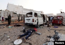 The dead body of an unidentified man is seen at the scene of an explosion in Mogadishu, Somalia, Nov. 9, 2018.
