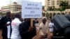 FILE - A Cameroonian journalist holds a sign reading "No to the persecution of journalists" during a free speech rally in Yaounde, Cameroon, May 3, 2010. 