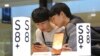 FILE - Students try out a Samsung Electronics Galaxy S8 Plus smartphone at its shop in Seoul, South Korea, April 27, 2017. 