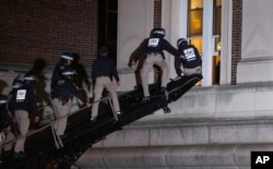 Using a tactical vehicle, New York City police enter an upper floor of Hamilton Hall on the Columbia University campus in New York Tuesday, April 30, 2024, after a building was taken over by protesters earlier Tuesday. (AP Photo/Craig Ruttle)