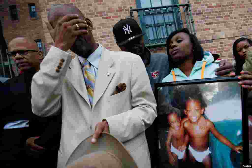 Mourners grieve at a vigil in honor of Edward and Edwin Bryant, twin brothers who were shot and killed in Chicago, Illinois, Oct. 31, 2016.