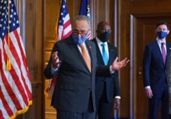 On the first full day of the Democratic majority in the Senate, Majority Leader Chuck Schumer, D-N.Y., left, is joined by Sen. Raphael Warnock, D-Ga., center, and Sen. Jon Ossoff, D-Ga., during a press event at the Capitol, Jan. 21, 2021.