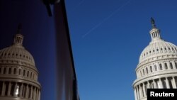 FILE - The U.S. Capitol dome and its reflection are seen in Washington, Jan. 15, 2020.