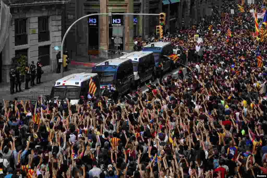 People shout during a protest outside the Spanish National Police Station in Barcelona, Spain.