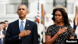 باراک اوباما رئیس جمهوری ایالات متحده (چپ) و میشل اوباما بانوی اول آمریکا در مراسم یادبود سیزدهمین سالگرد حملات ۱۱ سپتامبر - ۲۰ شهریور ۱۳۹۳