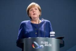 German Chancellor Angela Merkel addresses the media during a statement at the chancellery in Berlin, Germany, Nov. 9, 2020 on the results of the US elections.