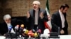 FILE - Iranian Foreign Minister Mohammad Javad Zarif (C) and diplomats leave a news conference in Vienna.