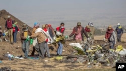 Rescuers work at the scene of an Ethiopian Airlines flight crash near Bishoftu, or Debre Zeit, south of Addis Ababa, Ethiopia, Monday, March 11, 2019. (AP Photo/Mulugeta Ayene)