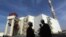 FILE - Iranian workers stand in front of the Bushehr nuclear power plant, about 1,200 km (746 miles) south of Tehran.