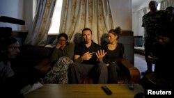 Israeli trekkers Maya Ora (R) along with Yakov Megreli (C) and Linor Kajan (L), who were rescued from an avalanche by the Nepalese army, speak with the media while undergoing treatment at the Army Hospital in Kathmandu, Nepal, Oct. 16, 2014.