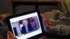 United Kingdom, Teacher Wendy Couldridge watches on a device as Britain's Prime Minister Boris Johnson