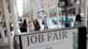 FILE - Signage for a job fair is seen on 5th Avenue in Manhattan, New York City, Sept. 3, 2021. 