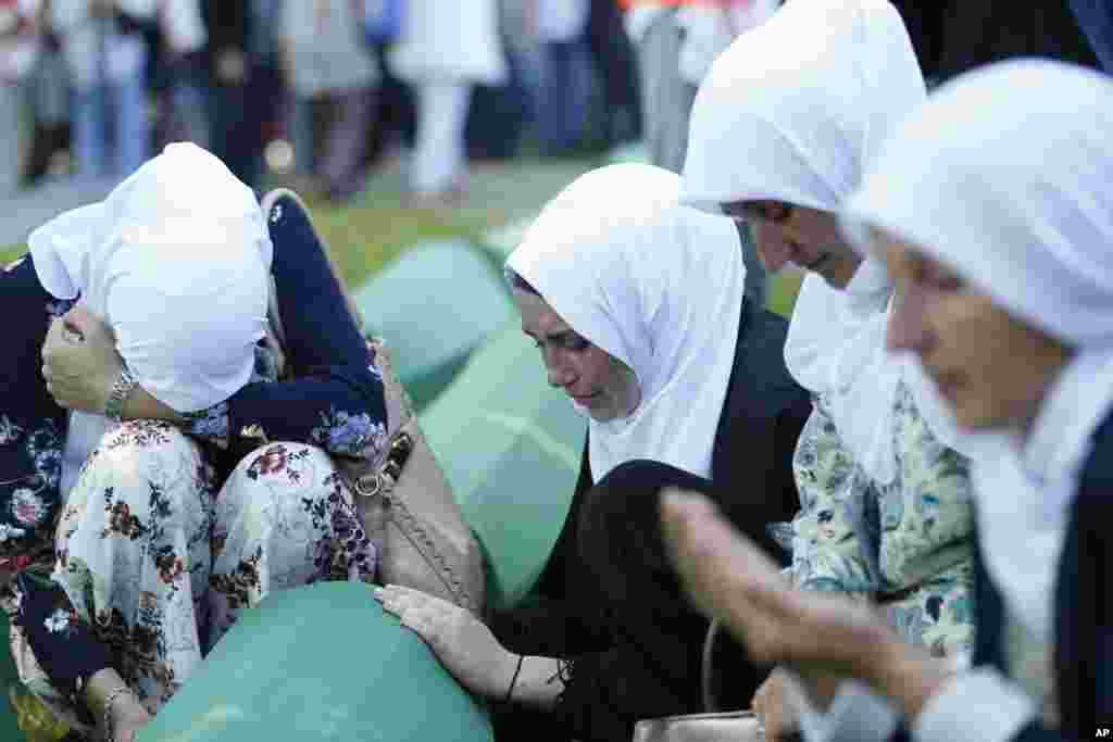 Bosnian Muslim women react near the coffin of one of the 35 identified victims of the 1995 massacre, at the memorial center of Potocari near Srebrenica, 150 kilometers northeast of Sarajevo. Thousands of Bosnian Muslims have gathered in Srebrenica on the 23rd anniversary of Europe&#39;s worst massacre since World War II to hold prayers and attend the funeral for 35 recently identified victims.