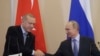 Russian President Vladimir Putin, right, and Turkish President Recep Tayyip Erdogan shake hands after their joint news conference following their talks in the Bocharov Ruchei residence in the Black Sea resort of Sochi, Russia, Oct. 22, 2019. 