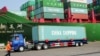 A truck transporting a container leaves the port of Qingdao, in northeast China's Liaoning province, Jan. 20, 2014.