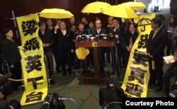 多名泛民主派立法会议员撑起黄伞并高举标语离场，公民党党魁梁家杰(发言者)表示，抗议梁振英施政报告没有提及真普选诉求。（图片由公民党提供）