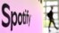 FILE - A person walks past a banner with an Spotify logo at the Frankfurt, Germany, book fair Oct. 17, 2024.