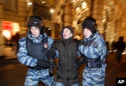 FILE - Police detain a man during an unsanctioned protest in Moscow, Russia, Dec. 30, 2014.