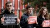 FILE - Protesters hold banners outside the building where Jeremy Corbyn, Leader of Britain's opposition Labor Party, attended the launch of Labor's General Election manifesto, at Birmingham City University, England, Nov. 21, 2019. 