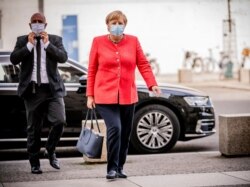 FILE - Chancellor Angela Merkel arrives for a meeting of her Christian Union parties faction at the Reichstag building in Berlin, Germany, Sept. 8, 2020.