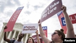 FILE - Supporters of the Affordable Care Act rally before the Supreme Court upheld the law at the Supreme Court in Washington, June 25, 2015.