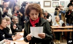 Gordana Siljanovska Davkova, a presidential candidate for the opposition conservative VMRO-DPMNE party, looks at her ballot before voting for the presidential election at a polling station, in Skopje, North Macedonia, May 5, 2019.