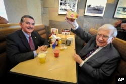 Berkshire Hathaway's Warren Buffett, right, at a Dairy Queen event on May 20, 2013 in Omaha, Nebraska.