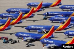 FILE - A number of grounded Southwest Airlines Boeing 737 MAX 8 aircraft are shown parked at Victorville Airport in Victorville, California, March 26, 2019.